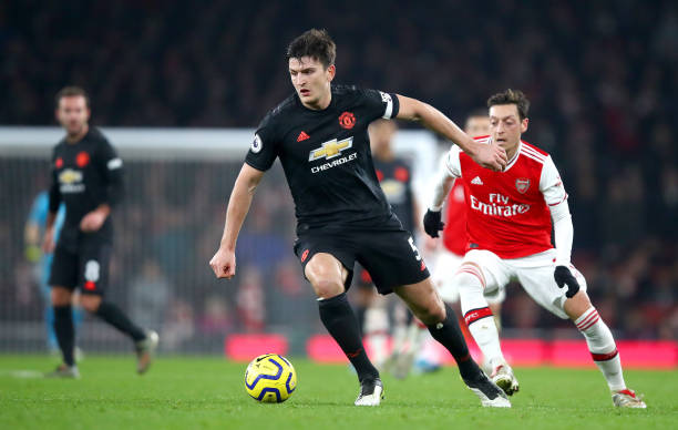 LONDON, ENGLAND - JANUARY 01: Harry Maguire of Manchester United runs with the ball during the Premier League match between Arsenal FC and Manchest...