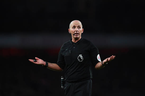 LONDON, ENGLAND - JANUARY 18: Referee Mike Dean gestures as he referees his 500th Premier League match during the Premier League match between Arse...