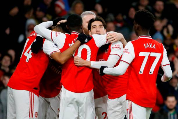 Arsenal players celebrate their third goal scored by Arsenal's Gabonese striker Pierre-Emerick Aubameyang during the English Premier League footbal...