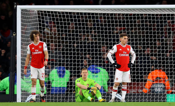 David Luiz , Bernd Leno and Lucas Torreira of Arsenal FC look dejected after their side concede their second goal during the UEFA Europa League round of 32 second leg match between Arsenal FC and Olympiacos FC at Emirates Stadium on February 27, 2020 in London, United Kingdom.