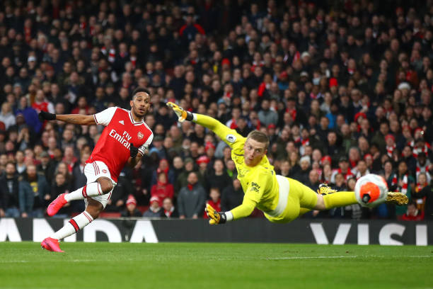 Pierre-Emerick Aubameyang of Arsenal scores his team's second goal past Jordan Pickford of Everton during the Premier League match between Arsenal FC and Everton FC at Emirates Stadium on February 23, 2020 in London, United Kingdom.