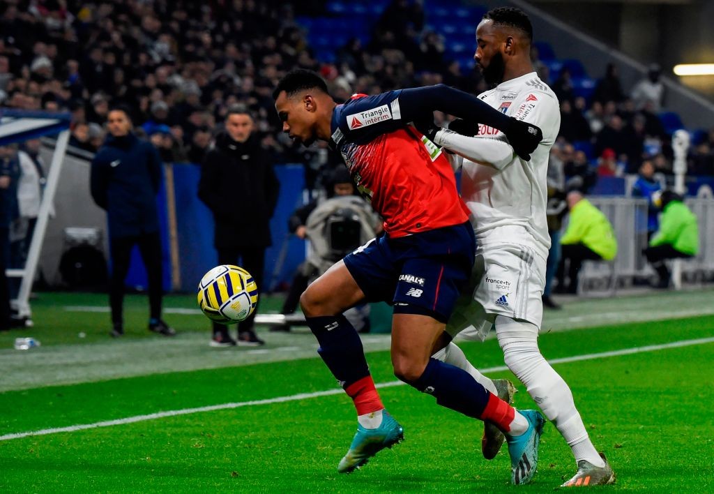 Lille's Brazilian defender Gabriel dos Santos Magalhaes (L) fights for the ball with Lyon's French forward Moussa Dembele during the French League ...