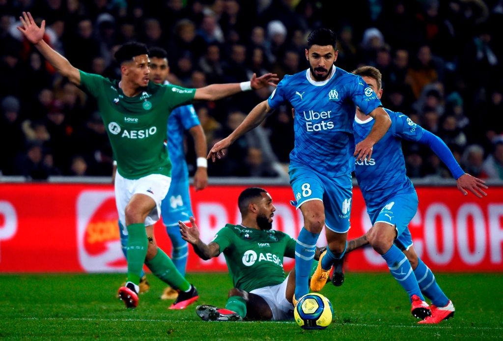 Saint-Etienne's French defender William Saliba (L) and Saint-Etienne's French midfielder Yann Mvila (C) react as Marseille's French midfielder Morg...