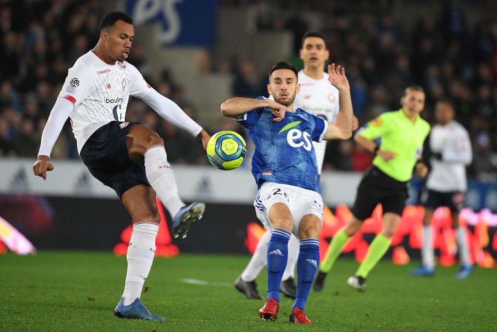 Lille's Brazilian defender Gabriel Magalhaes (L) vies with Strasbourg's French midfielder Adrien Thomasson during the French L1 football match betw...