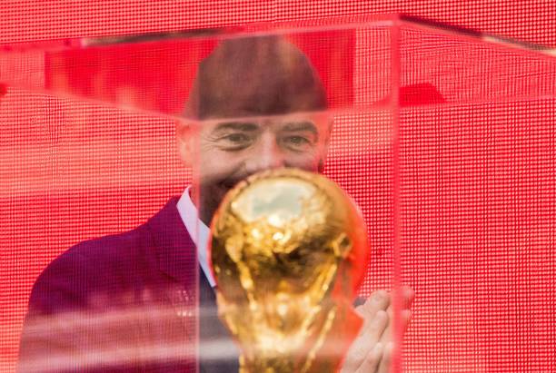 FIFA President Gianni Infantino looks at the FIFA World Cup Trophy during the trophy tour opening ceremony at Luzhniki stadium in Moscow on Septemb...