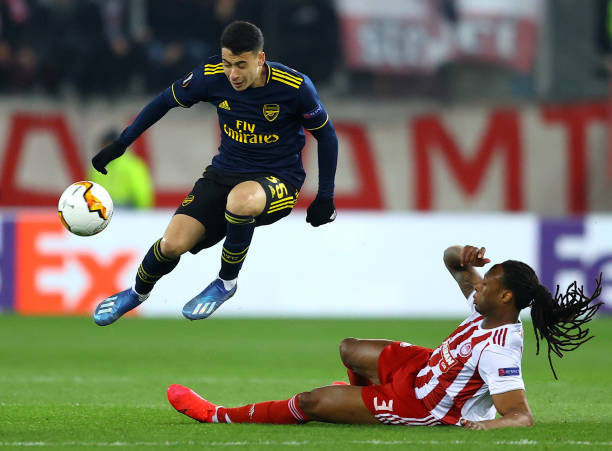 Gabriel Martinelli of Arsenal is challenged by Ruben Semedo of Olympiacos FC during the UEFA Europa League round of 32 first leg match between Olympiacos FC and Arsenal FC at Karaiskakis Stadium on February 20, 2020 in Piraeus, Greece.