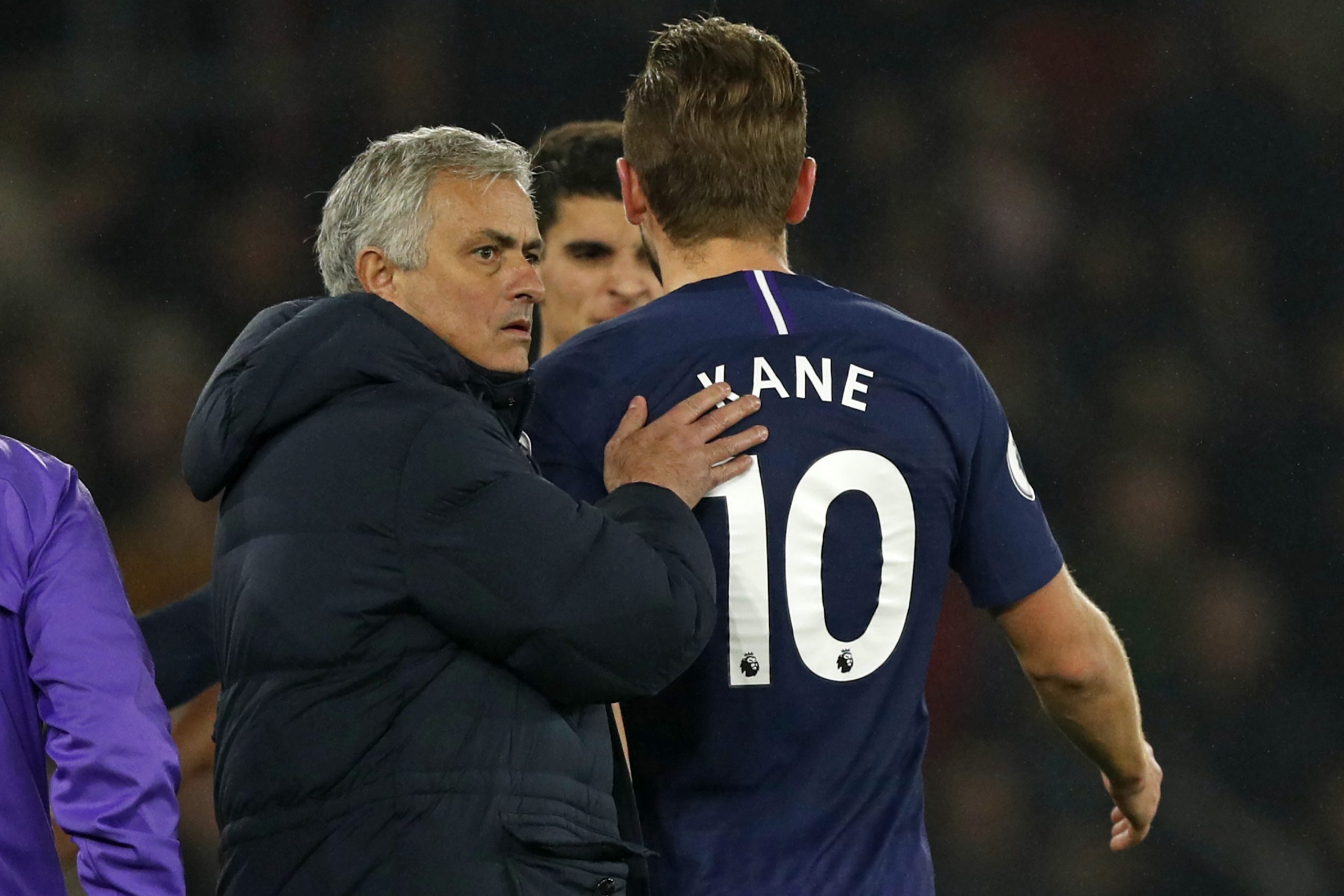 Tottenham Hotspur's Portuguese head coach Jose Mourinho (L) consoles Tottenham Hotspur's English striker Harry Kane (R) as he leaves the pitch havi...