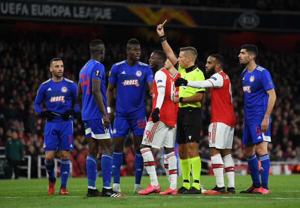 Arsenal-Atletico ref sent off Hincapie earlier this year 3 Ousseynou Ba of Olympiacos FC reveives a yellow card from referee Davide Massa during the UEFA Europa League round of 32 second leg match between Arsenal FC and Olympiacos FC at Emirates Stadium on February 27, 2020 in London, United Kingdom.