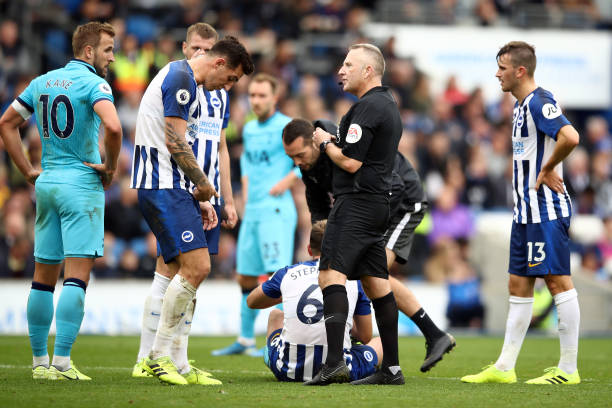 Referee Jonathan Moss talks to Lewis Dunk during the Premier League match between Brighton & Hove Albion and Tottenham Hotspur at American Express Community Stadium on October 05, 2019 in Brighton, United Kingdom. 