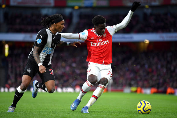 Bukayo Saka of Arsenal and Valentino Lazaro of Newcastle United during the Premier League match between Arsenal FC and Newcastle United at Emirates...