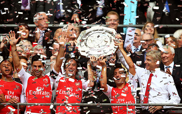 13 Arsene Wenger-era players remain at Arsenal 2 LONDON, ENGLAND - AUGUST 10: Santi Cazorla of Arsenal holds up the trophy watched by Arsene Wenger, manager of Arsenal after the FA Community Shield match between Manchester City and Arsenal at Wembley Stadium on August 10, 2014 in London, England. (Photo by Clive Mason/Getty Images)