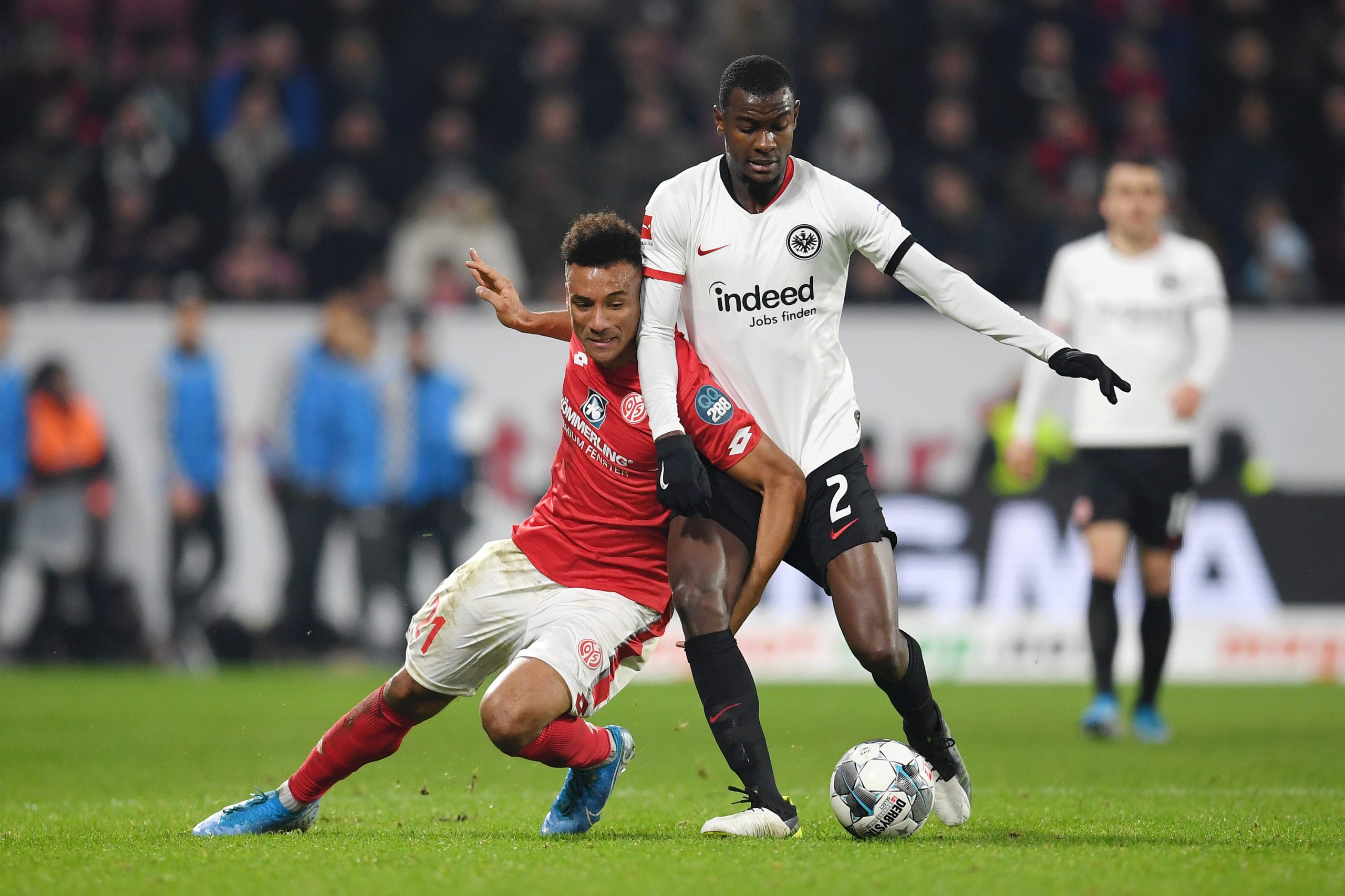MAINZ, GERMANY - DECEMBER 02: Karim Onisiwo of 1. FSV Mainz 05 battles for possession with Evan Ndicka of Eintracht Frankfurt during the Bundesliga...