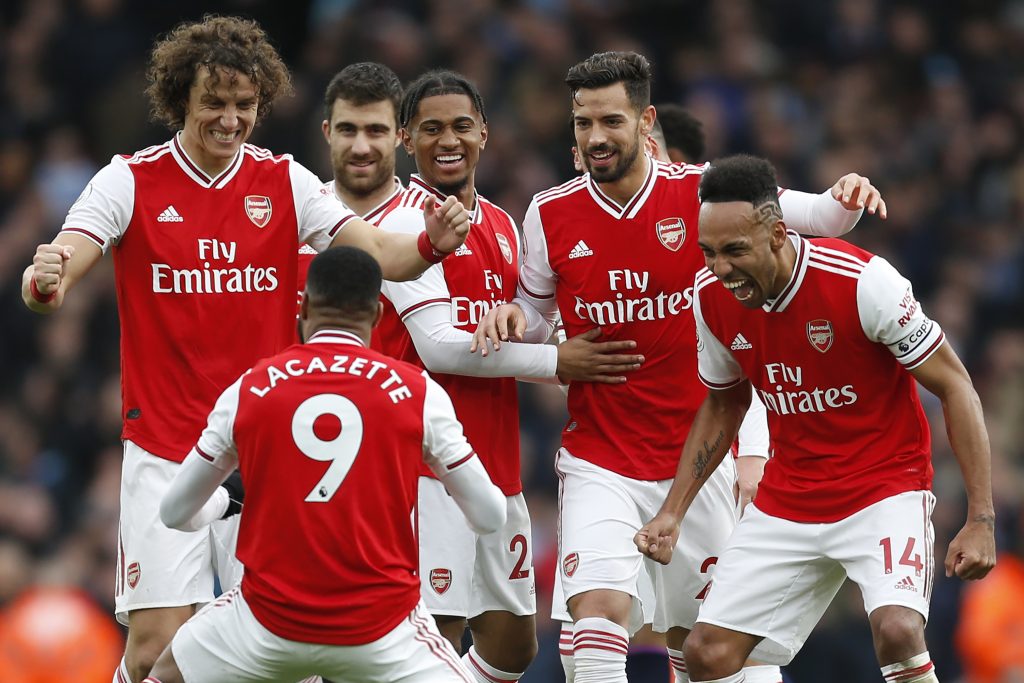 Arsenal's French striker Alexandre Lacazette (C) celebrates with teammates after scoring the opening goal of the English Premier League football match between Arsenal and West Ham at the Emirates Stadium in London on March 7, 2020.