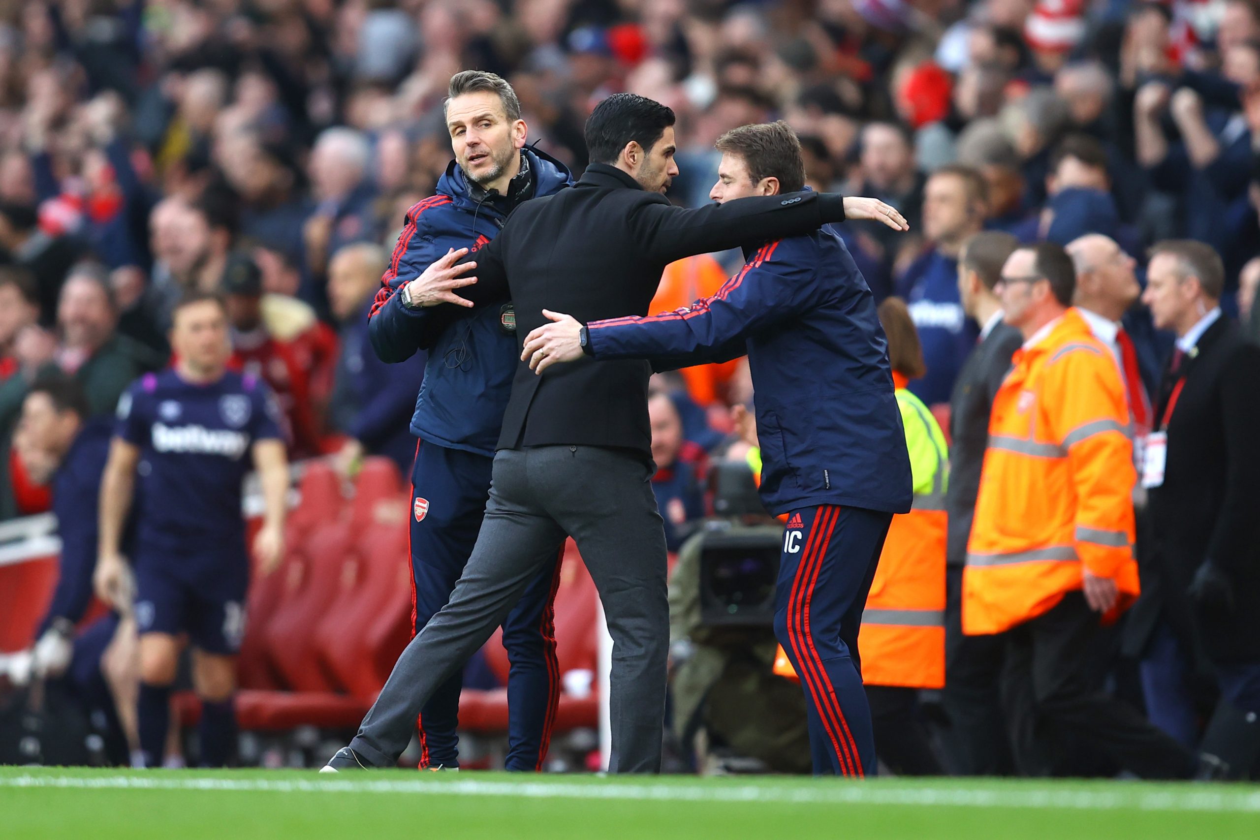 Mikel Arteta, Manager of Arsenal embraces his coaching staff following his sides victory in the Premier League match between Arsenal FC and West Ha...