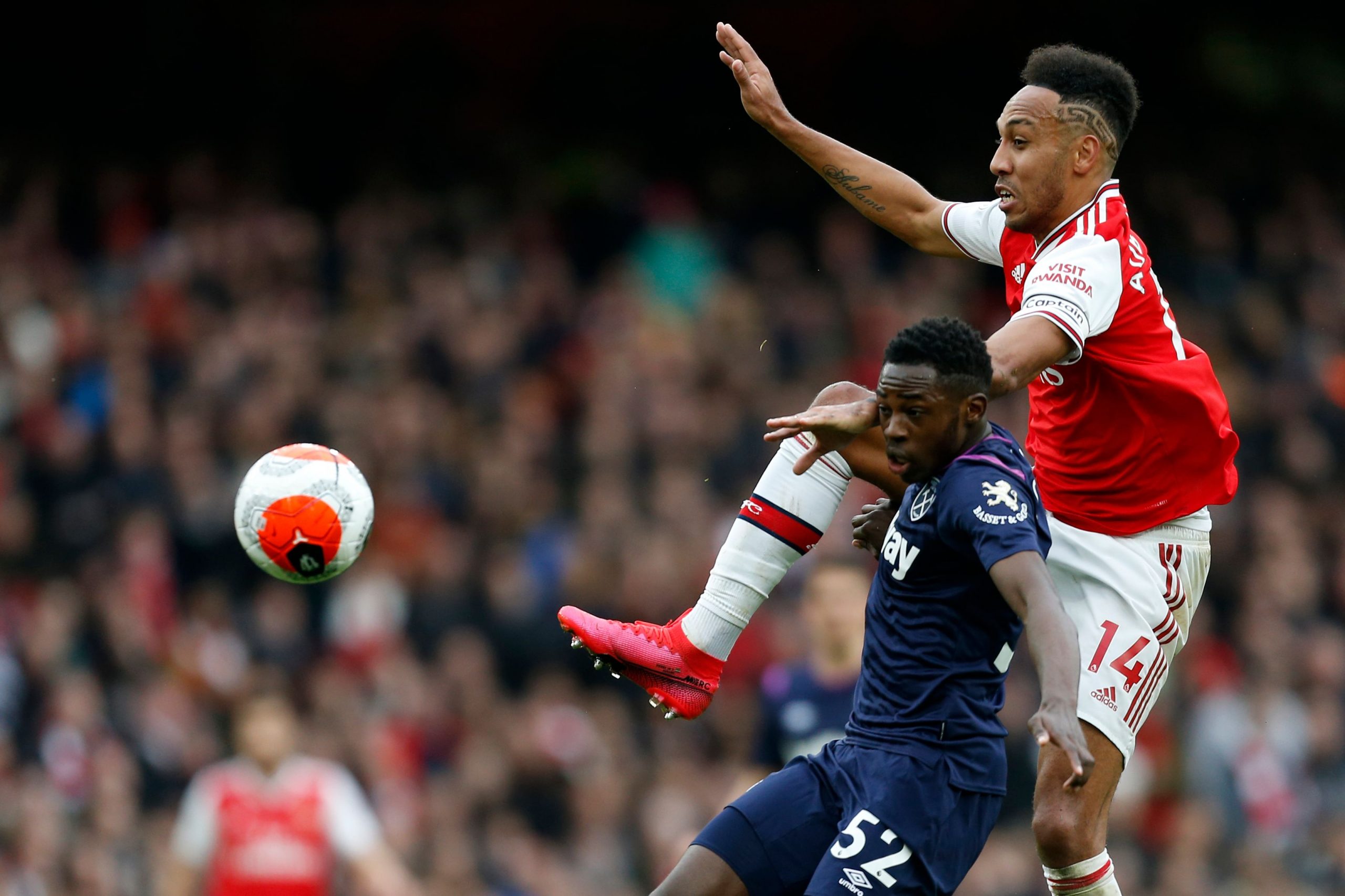 Arsenal's Gabonese striker Pierre-Emerick Aubameyang (R) vies with West Ham United's English midfielder Jeremy Ngakia (C) during the English Premie...