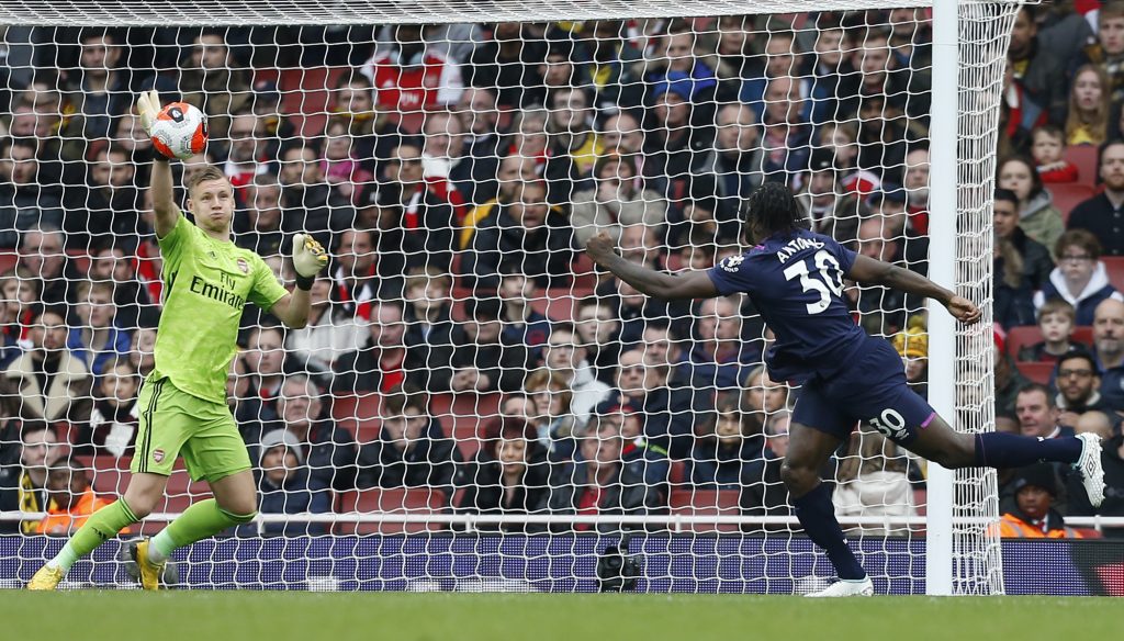 Arsenal's German goalkeeper Bernd Leno (L) makes a save from West Ham United's English midfielder Michail Antonio (R) during the English Premier League football match between Arsenal and West Ham at the Emirates Stadium in London on March 7, 2020.
