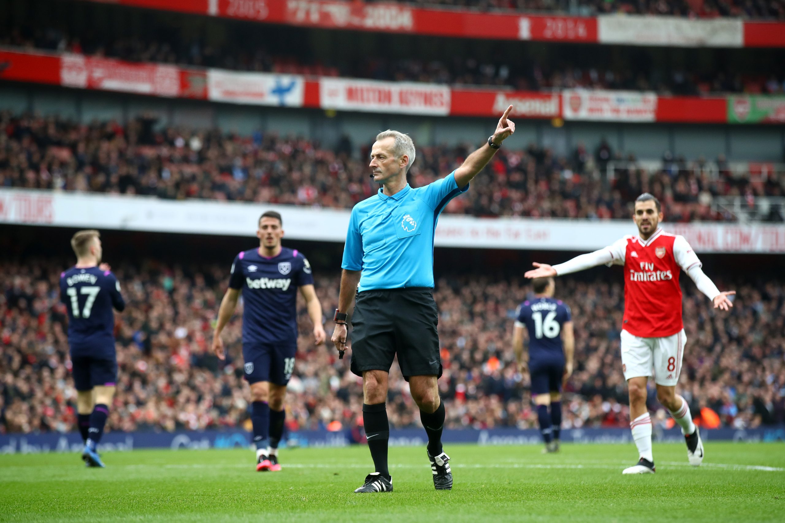 Referee Martin Atkinson makes a decision during the Premier League match between Arsenal FC and West Ham United at Emirates Stadium on March 07, 20...