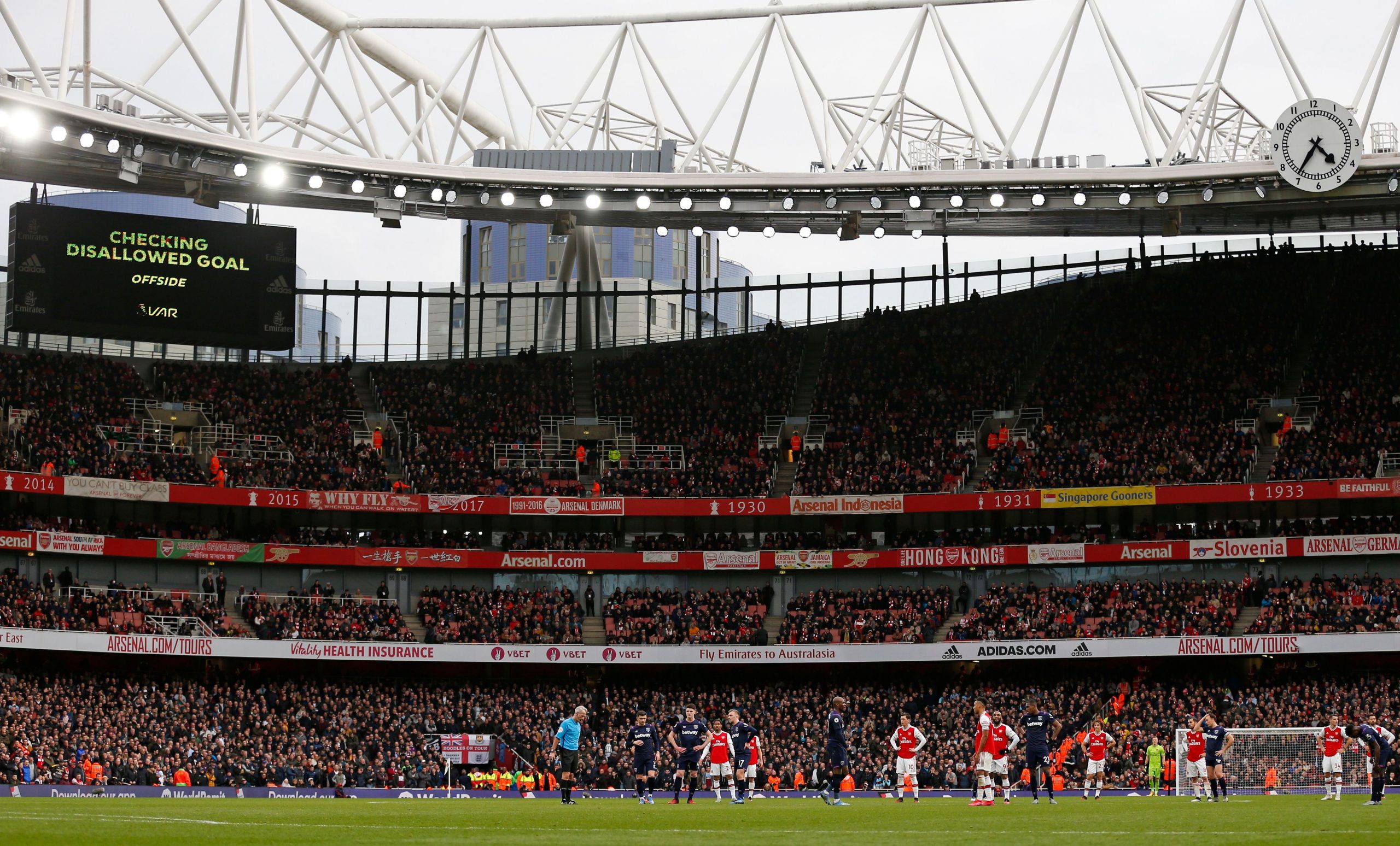 Players wait on the pitch while a VAR (Video Assistant Referee) review is conducted before awarding a goal to Arsenal during the English Premier Le...