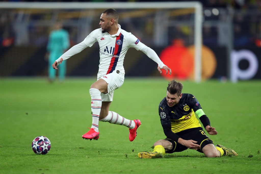 Arsenal still monitoring Kurzawa for summer free transfer 2 DORTMUND, GERMANY - FEBRUARY 18: Lukas Piszczek of Dortmund is challenged by Layvin Kurzawa of Paris Saint-Germain during the UEFA Champions League round of 16 first leg match between Borussia Dortmund and Paris Saint-Germain at Signal Iduna Park on February 18, 2020, in Dortmund, Germany. (Photo by Alex Grimm/Getty Images)