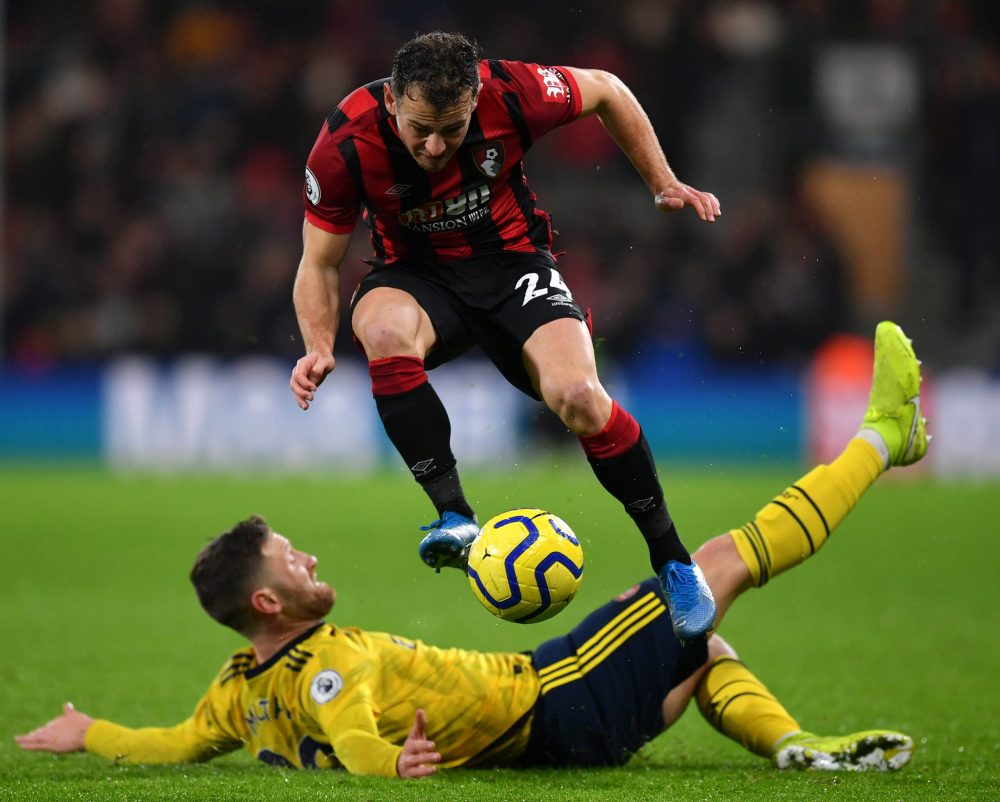 BOURNEMOUTH, ENGLAND - DECEMBER 26: Ryan Fraser of AFC Bournemouth jumps past a tackle from Shkodran Mustafi of Arsenal during the Premier League m...