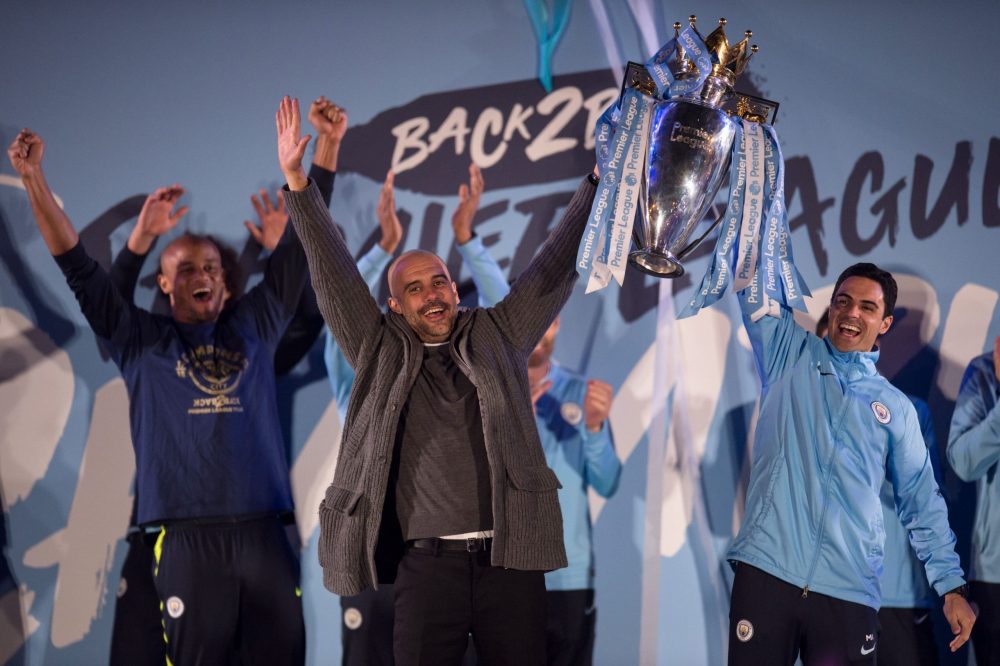 Manchester City's Spanish manager Pep Guardiola (C), Manchester City assistant coach Mikel Arteta (R) and Manchester City's Belgian defender Vincen...