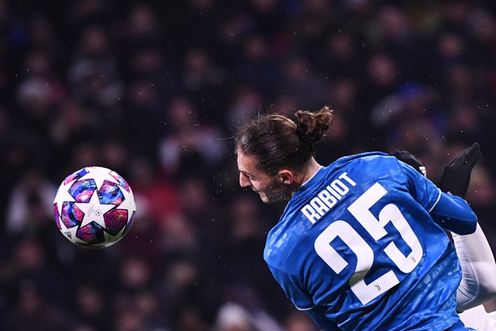 Juventus' French midfielder Adrien Rabiot heads the ball during the UEFA Champions League round of 16 first-leg football match between Lyon and Juv...