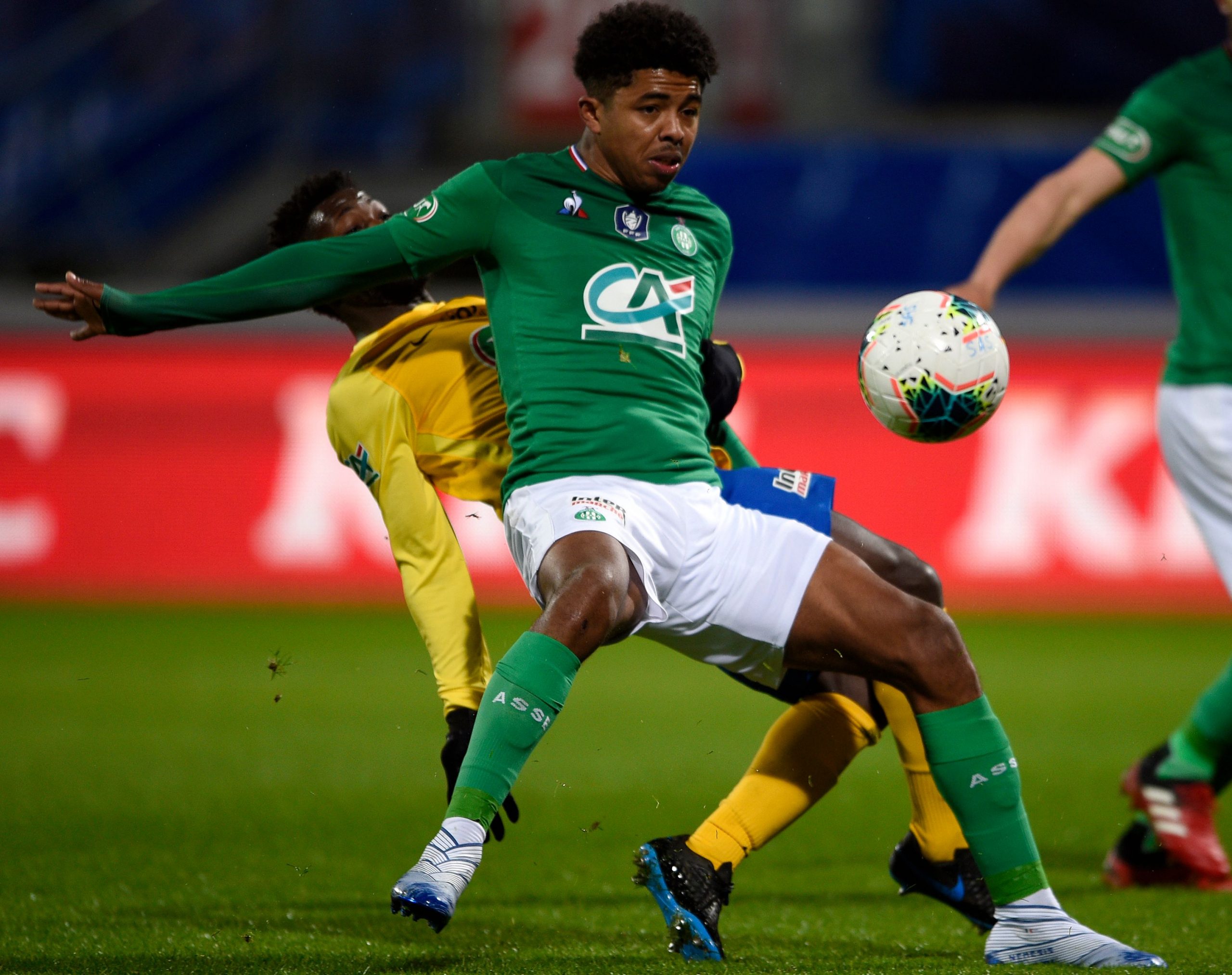 Saint-Etienne's French defender Wesley Fofana (front) vies with Epinal's French forward Mickael Biron during the French Cup quarter-final football ...