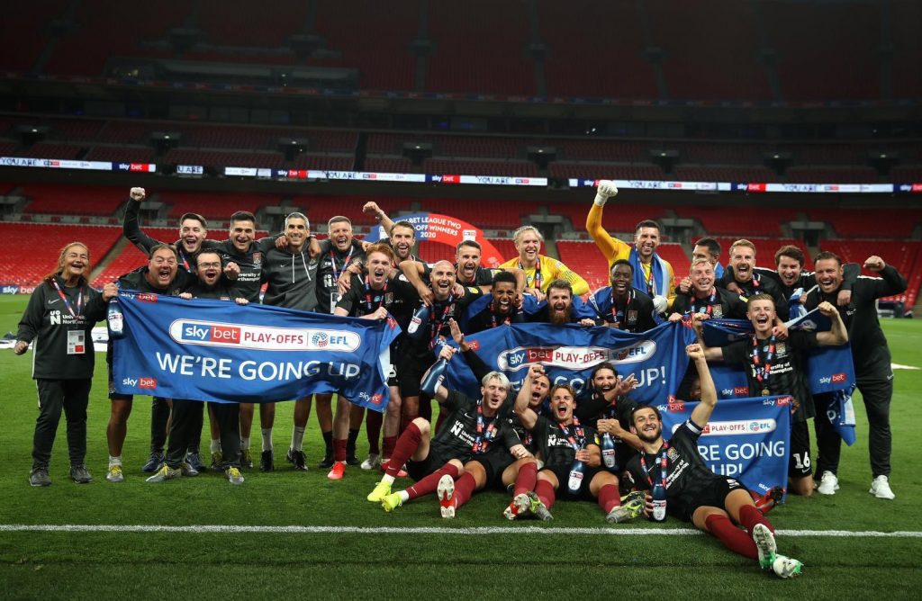 James Olayinka and the Northampton Town squad celebrating promotion at Wembley (Photo via NTFC on Twitter)