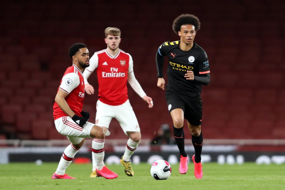 LONDON, ENGLAND - FEBRUARY 28: Leroy Sane of Manchester City runs with the ball under pressure from Trae Coyle of Arsenal during the Premier League 2 match between Arsenal U23 and Manchester City U23 at Emirates Stadium on February 28, 2020 in London, England. (Photo by Linnea Rheborg/Getty Images)