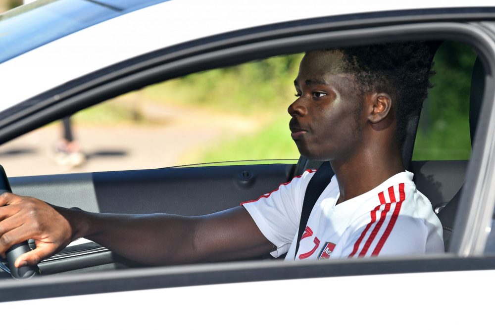 Arsenal's English striker Bukayo Saka leaves Arsenal's Colney training centre north of London on May 20, 2020 as training continues for Premier Lea...