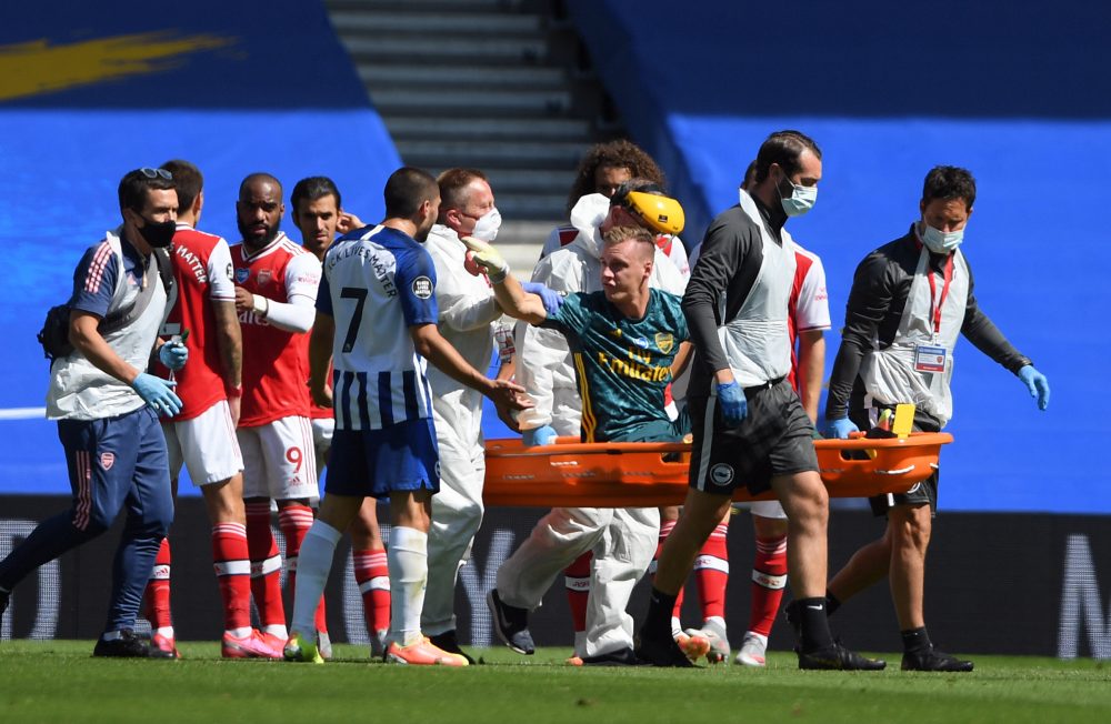 Arsenal's German goalkeeper Bernd Leno (on stretcher) remonstrates with Brighton's French striker Neal Maupay after the keeper was injured during t...