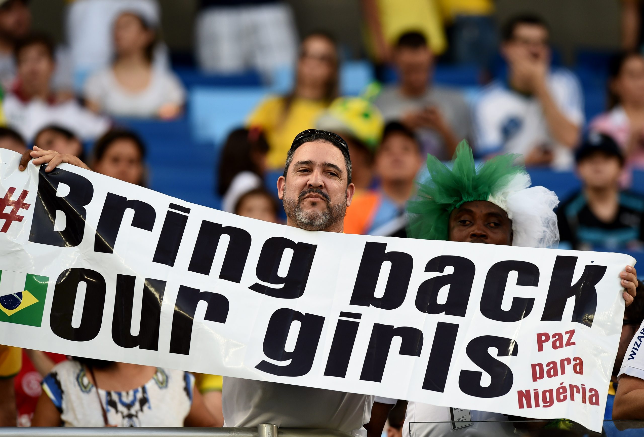 Boko Haram killed both parents but 17yo winger using faith and Mesut Ozil to fulfil dream 2 A man holds a banner "Bring back our girls" before the Group F football match between Nigeria and Bosnia-Hercegovina at the Pantanal Arena in Cuiaba during the 2014 FIFA World Cup on June 21, 2014. AFP PHOTO / JEWEL SAMAD