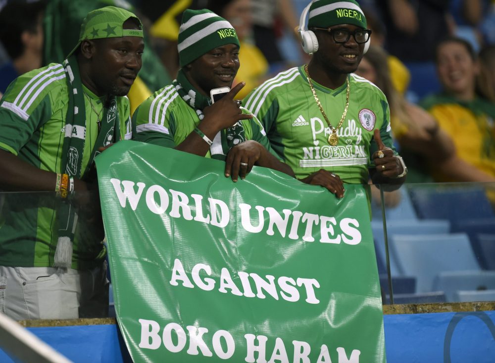 Nigeria's fans hold a banner reading "World Unites Against Boko Haram" before the Group F football match between Nigeria and Bosnia-Hercegovina at ...