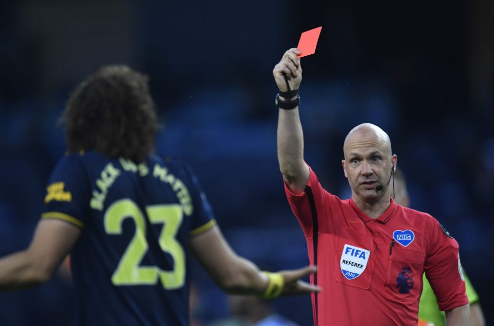MANCHESTER, ENGLAND - JUNE 17: David Luiz of Arsenal receives a red card from match referee Anthony Taylor during the Premier League match between ...