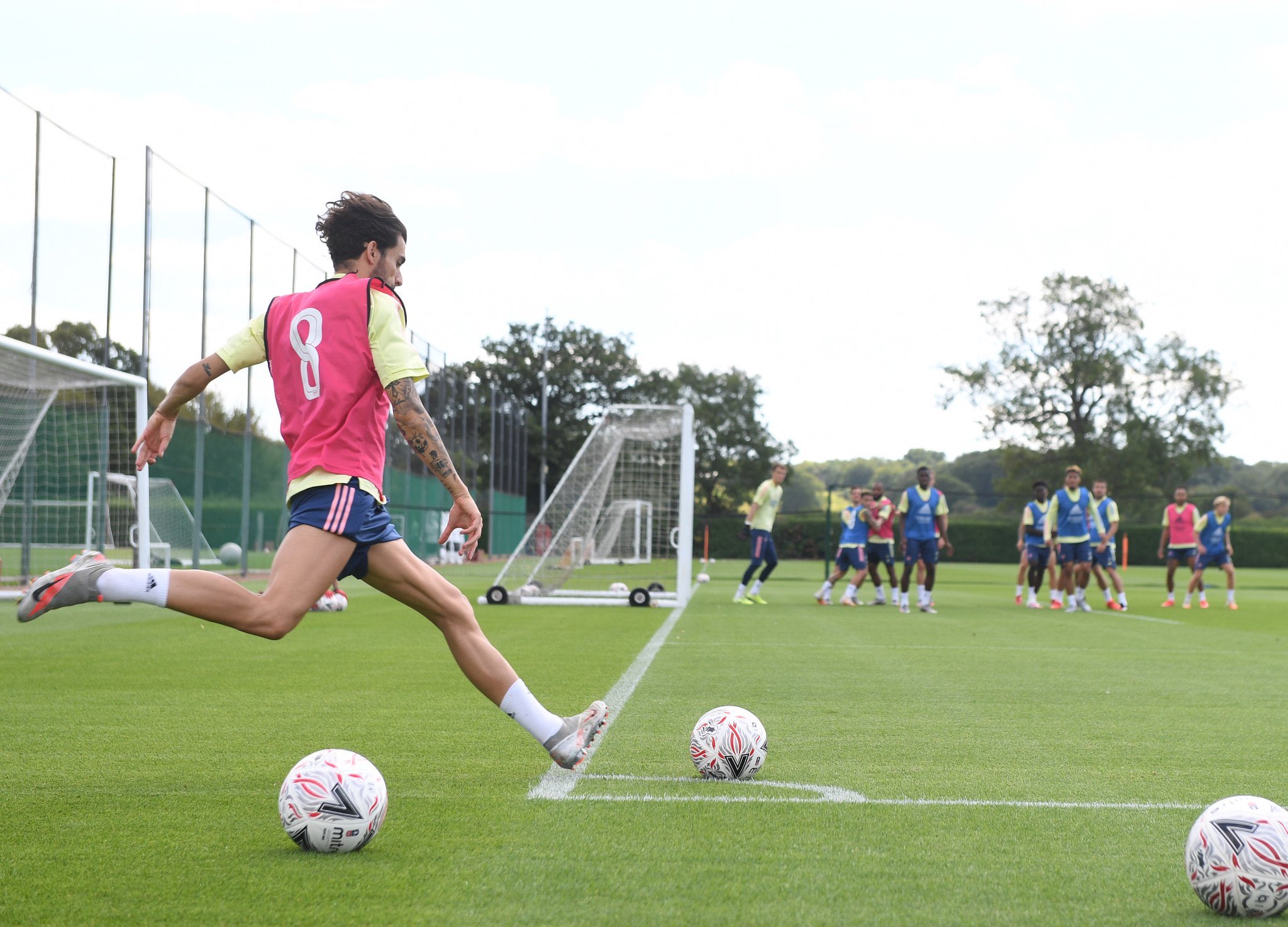 Dani Ceballos takes a corner in an Arsenal training session with William Saliba in the background (Photo via Stuart MacFarlane)
