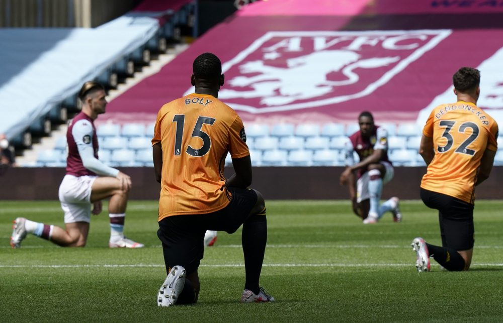 BIRMINGHAM, ENGLAND - JUNE 27: Willy Boly of Wolverhampton Wanderers and Leander Dendoncker of Wolverhampton Wanderers take a knee in support of the Black Lives Matter movement during the Premier League match between Aston Villa and Wolverhampton Wanderers at Villa Park on June 27, 2020 in Birmingham, England. (Photo by Tim Keeton/Pool via Getty Images)