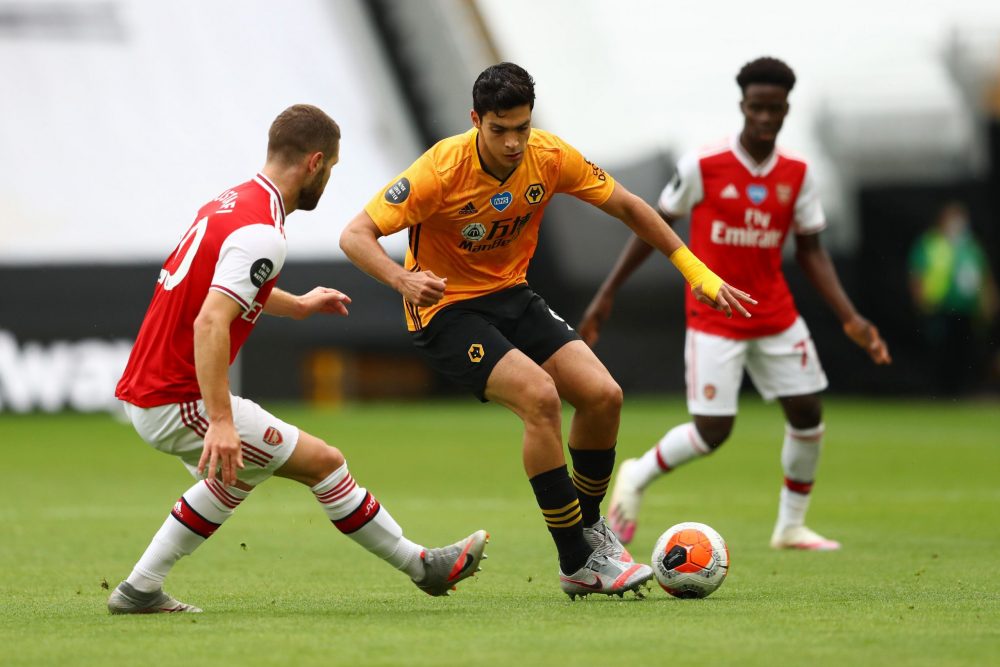 WOLVERHAMPTON, ENGLAND - JULY 04: Shkodran Mustafi of Arsenal and Raul Jimenez of Wolverhampton Wanderers battle for the ball during the Premier League match between Wolverhampton Wanderers and Arsenal FC at Molineux on July 04, 2020 in Wolverhampton, England. Football Stadiums around Europe remain empty due to the Coronavirus Pandemic as Government social distancing laws prohibit fans inside venues resulting in all fixtures being played behind closed doors. (Photo by Michael Steele/Getty Images)