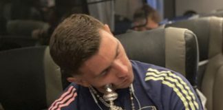 Emiliano Martinez, Arsenal goalkeeper, sleeps while hugging the FA Cup