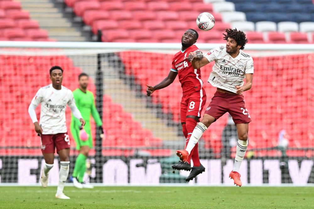 Arsenal's Egyptian midfielder Mohamed Elneny (R) jumps to head the ball against Liverpool's Guinean midfielder Naby Keita (2nd R) during the Englis...