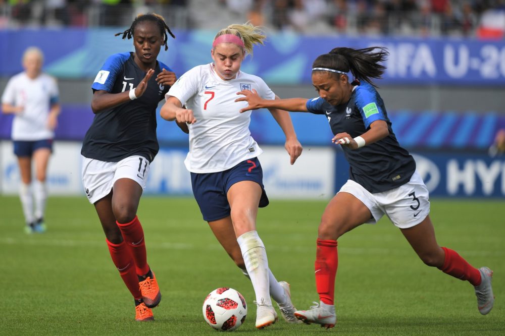 England's forward Alessia Russo (C) vies for the ball with France's forward Melvine Malard (L) and France's defender Selma Bacha (R) during the Wom...