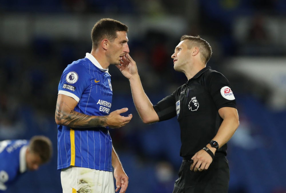 BRIGHTON, ENGLAND - SEPTEMBER 14: Referee Craig Pawson interacts with Lewis Dunk of Brighton and Hove Albion during the Premier League match between Brighton & Hove Albion and Chelsea at American Express Community Stadium on September 14, 2020 in Brighton, England. (Photo by Peter Cziborra/Pool via Getty Images)