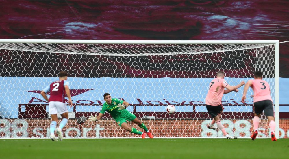 Aston Villa's Argentine goalkeeper Emiliano Martinez (C) dives to save a penalty taken by Sheffield United's English midfielder John Lundstram (2nd...