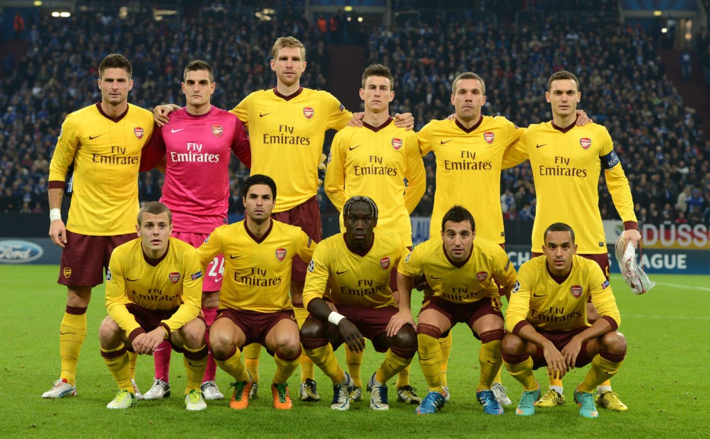 (Back row from L to R) Arsenal's French striker Olivier Giroud, Arsenal's Italian goalkeeper Vito Mannone,Arsenal's German defender Per Mertesacker, Arsenal's Belgian defender Laurent Koscielny, Arsenal's German striker Lukas Podolski, Arsenal's defender Thomas Vermaelen, (front row, from L-R) Arsenal's midfielder Jack Wilshere, Arsenal's Spanish midfielder Mikel Arteta, Arsenal's French defender Bacary Sagna, Arsenal's Spanish midfielder Santi Cazorla and Arsenal's midfielder Theo Walcott pose for photographers ahead of the UEFA Champions league group B football match between Schalke 04 and Arsenal in Gelsenkirchen, western Germany, on November 6, 2012.AFP PHOTO / PATRIK STOLLARZ (Photo credit should read PATRIK STOLLARZ/AFP via Getty Images)