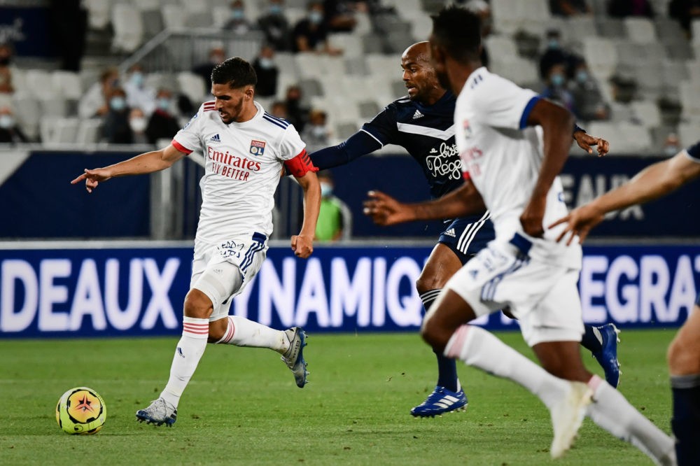 Lyon's French midfielder Houssem Aouar (L) dribbles during the French L1 football match between Girondins de Bordeaux and Lyon at the Matmut-Atlant...