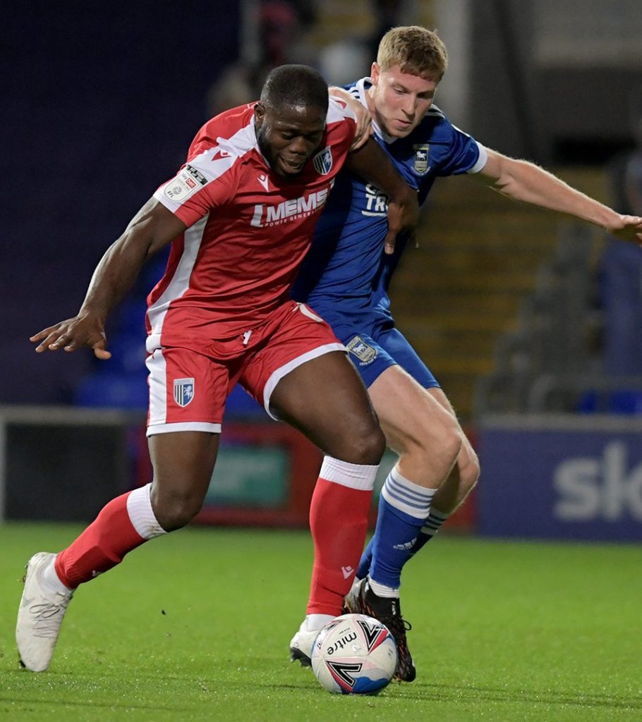 Mark McGuinness (R) challenging a Gillingham player (Photo via Ipswich Town on Twitter)