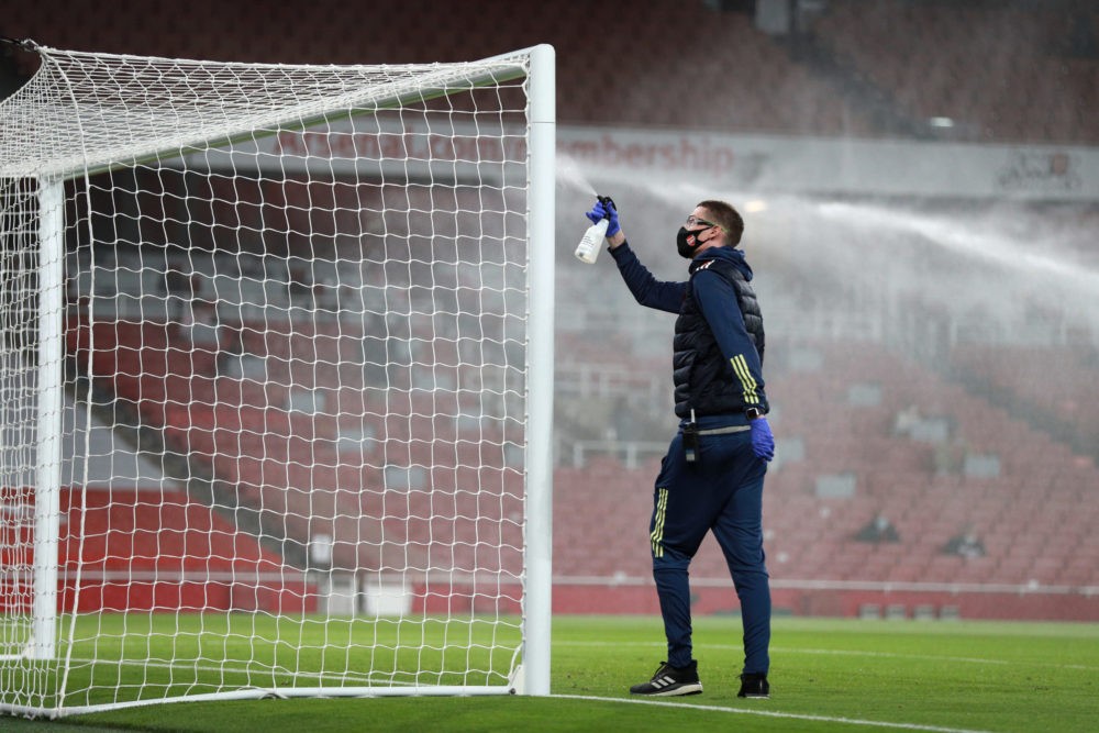 LONDON, ENGLAND: A member of staff disinfects the goal posts amidst the COVID-19 pandemic prior to the Premier League match between Arsenal and West Ham United at Emirates Stadium on September 19, 2020. (Photo by Ian Walton - Pool/Getty Images)