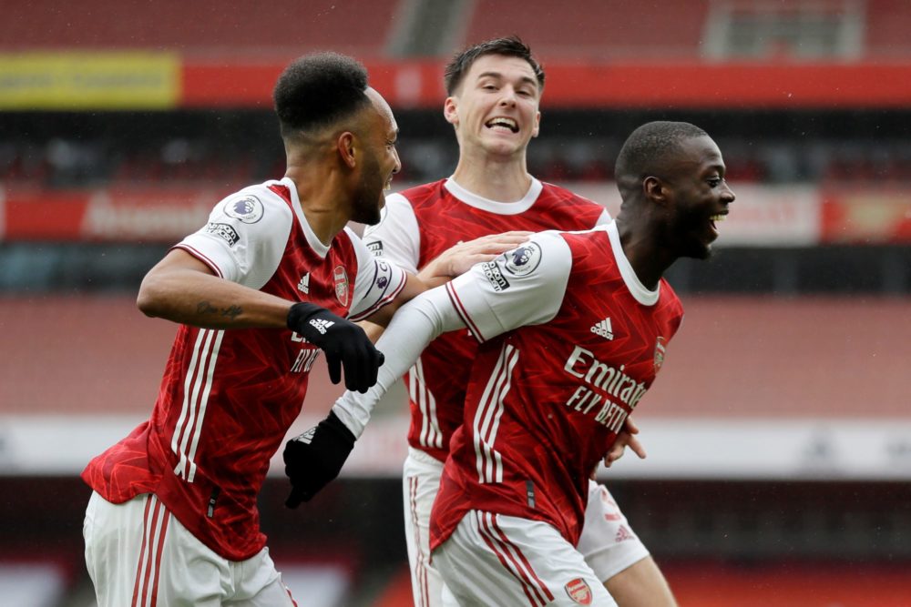 Arsenal's French-born Ivorian midfielder Nicolas Pepe (R) celebrates scoring his team's second goal during the English Premier League football matc...