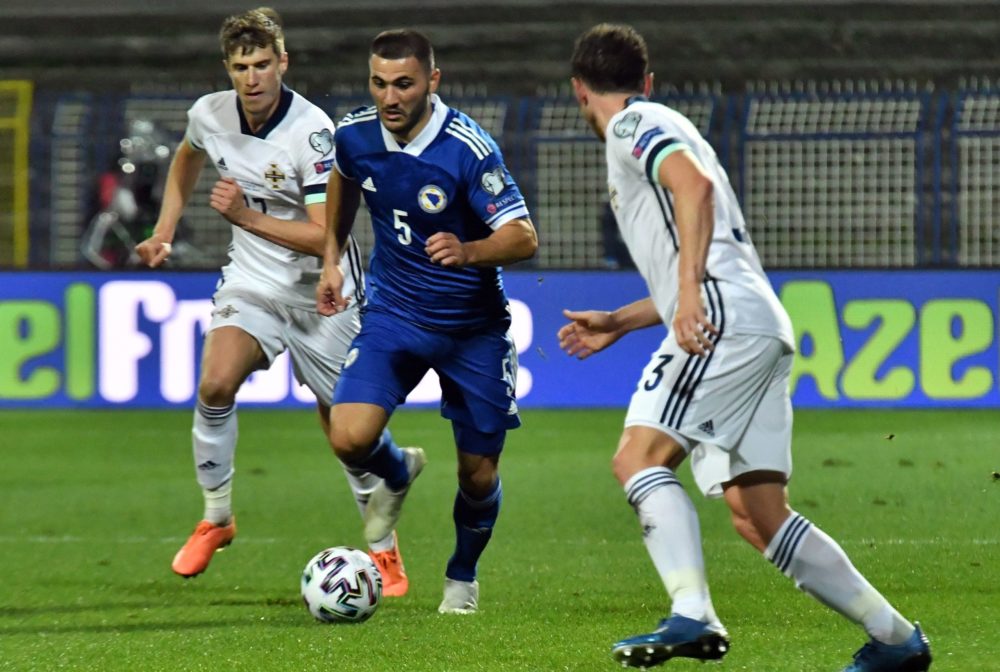 Bosnia and Herzegovina's defender Sead Kolasinac (C) vies with Northern Ireland's midfielder Corry Evans (R) Northern Ireland's forward Paddy McNai...