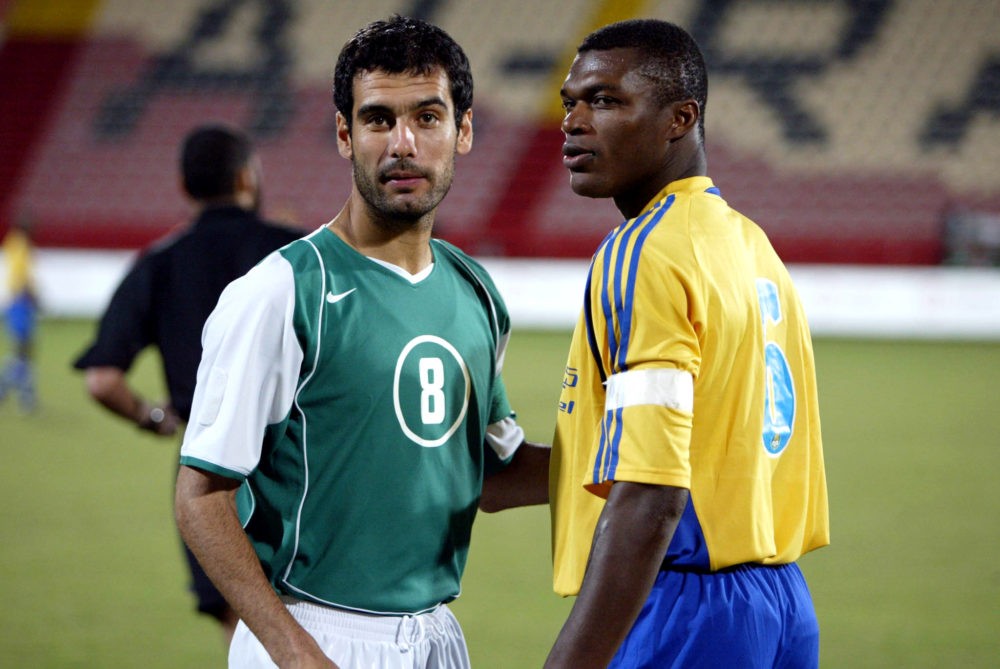 (FILES) -- A file photo taken 30 December 2004 shows Qatar's al-Ahli club Spanish midfielder Joseph Guardiola (L) standing next to Al-Gharrafa's French defender and former captain of the French national team, Marcel Desailly, during their Qatar Championships match in Doha. Barcelona's multi-decorated former captain Joseph Guardiola announced 13 November 2006 he was retiring from football. The 35-year-old midfielder, whose career was touched by a drugs scandal, hangs up his boots with half a dozen Spanish titles (1991-94, 1998-99), and a Champions League trophy as a member of Johan Cruyff's 1992 Barca 'dream team'. AFP PHOTO / KARIM JAAFAR (Photo by Karim JAAFAR and - / AFP FILES / AFP) (Photo by KARIM JAAFAR/AFP FILES/AFP via Getty Images)