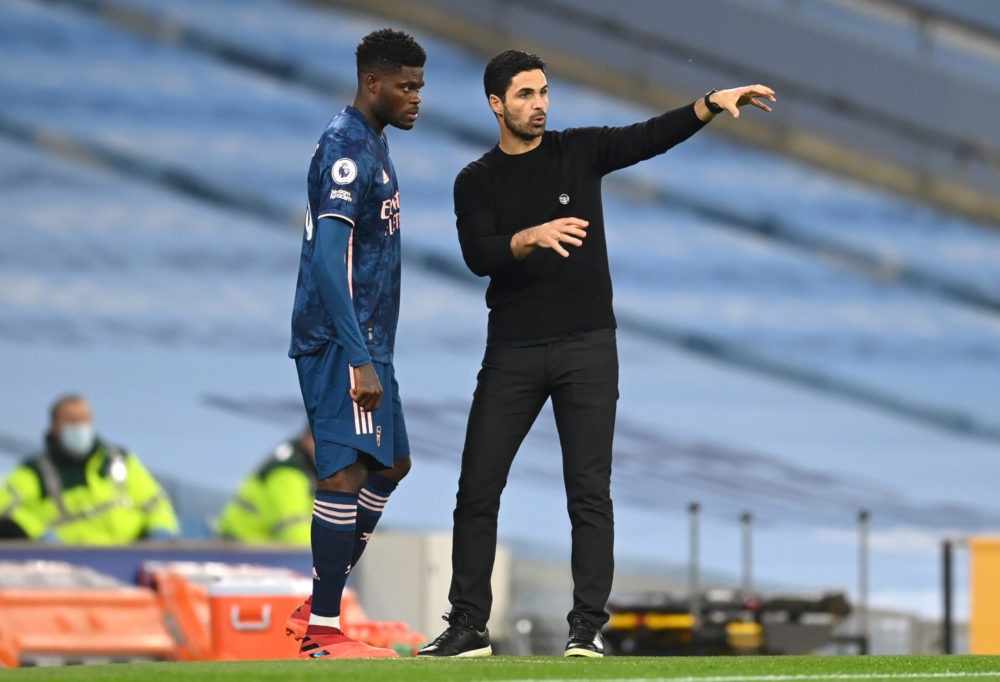 MANCHESTER, ENGLAND: Mikel Arteta, Manager of Arsenal talks to Thomas Partey of Arsenal before making his debut during the Premier League match bet...